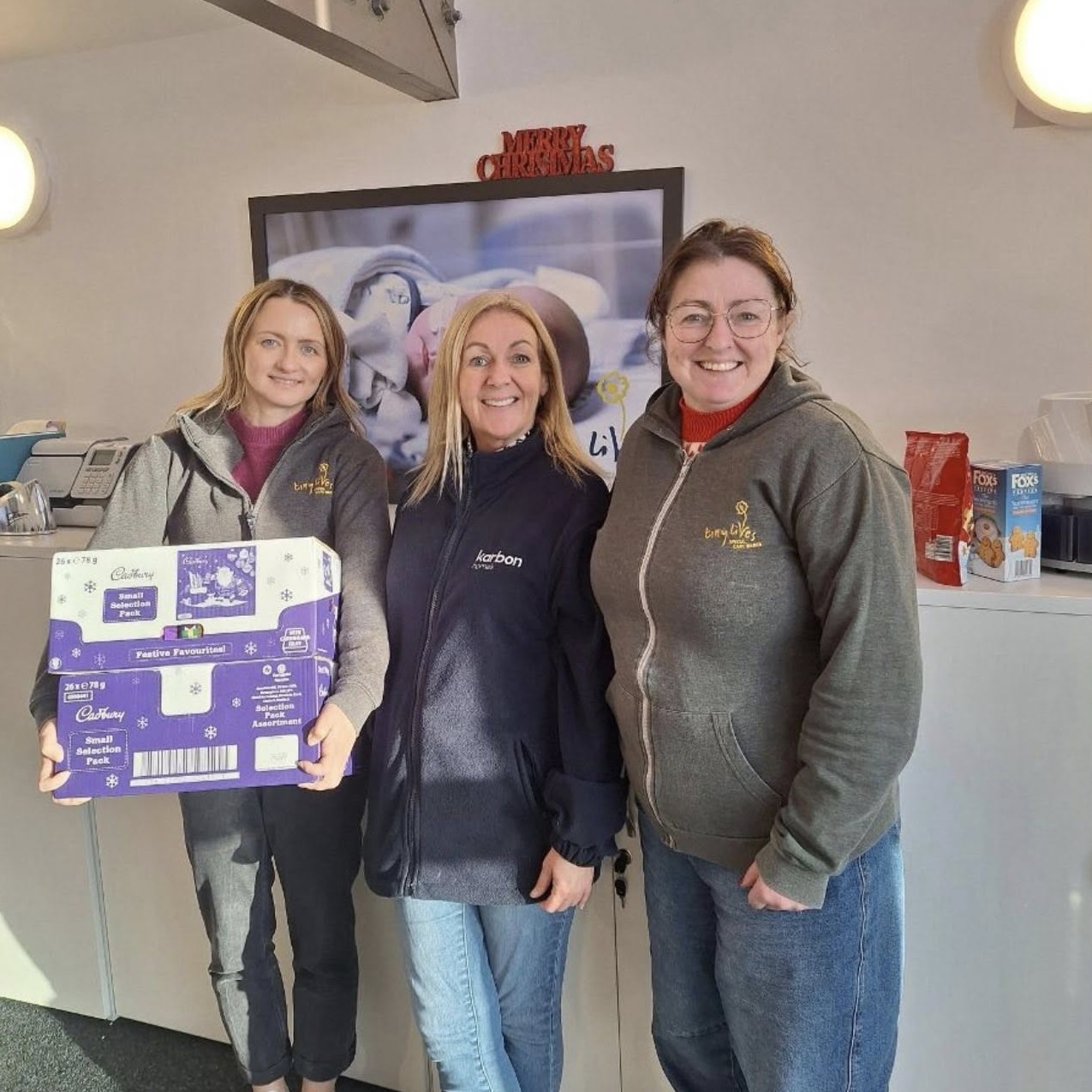 Women holding a selection box to donate to those in need