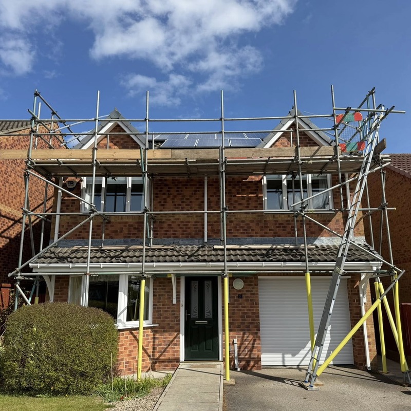 Scaffolding around a property where solar panel pigeon proofing is taking place
