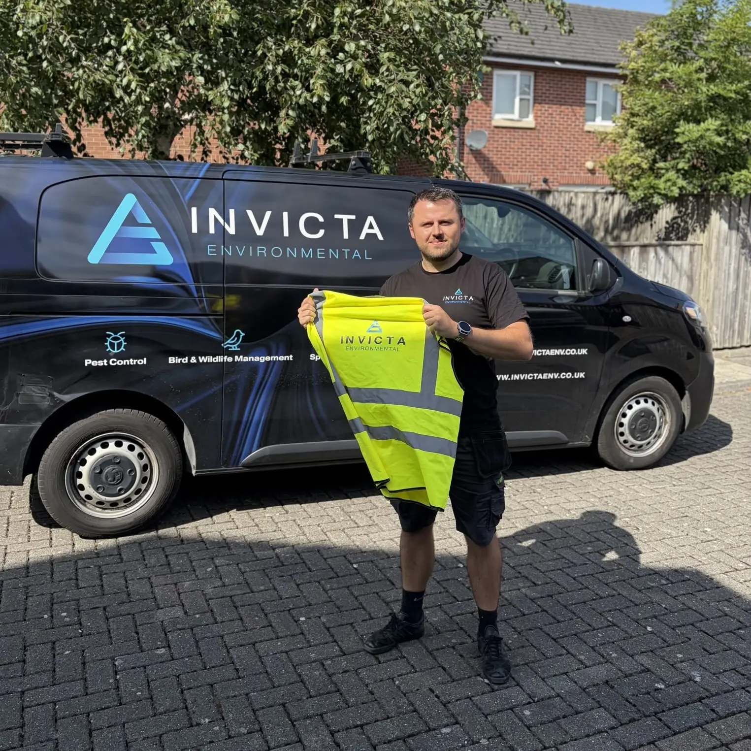 A team member in front of an Invicta Environmental branded van