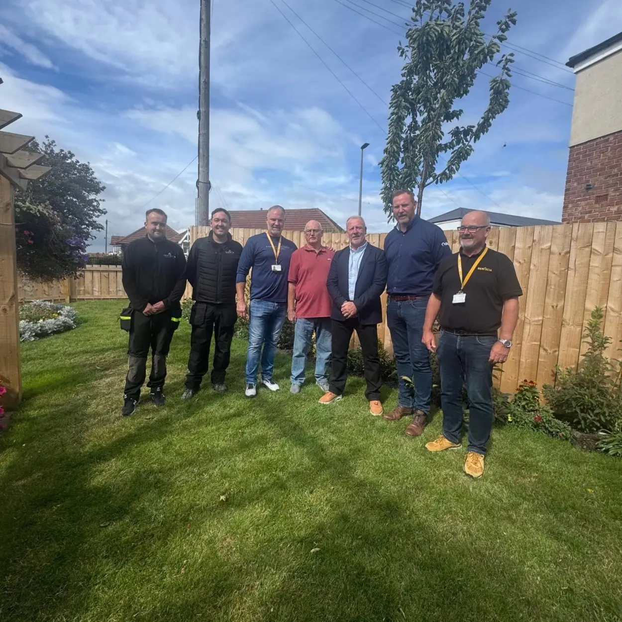 The Invicta team outside a newly-unveiled memorial garden