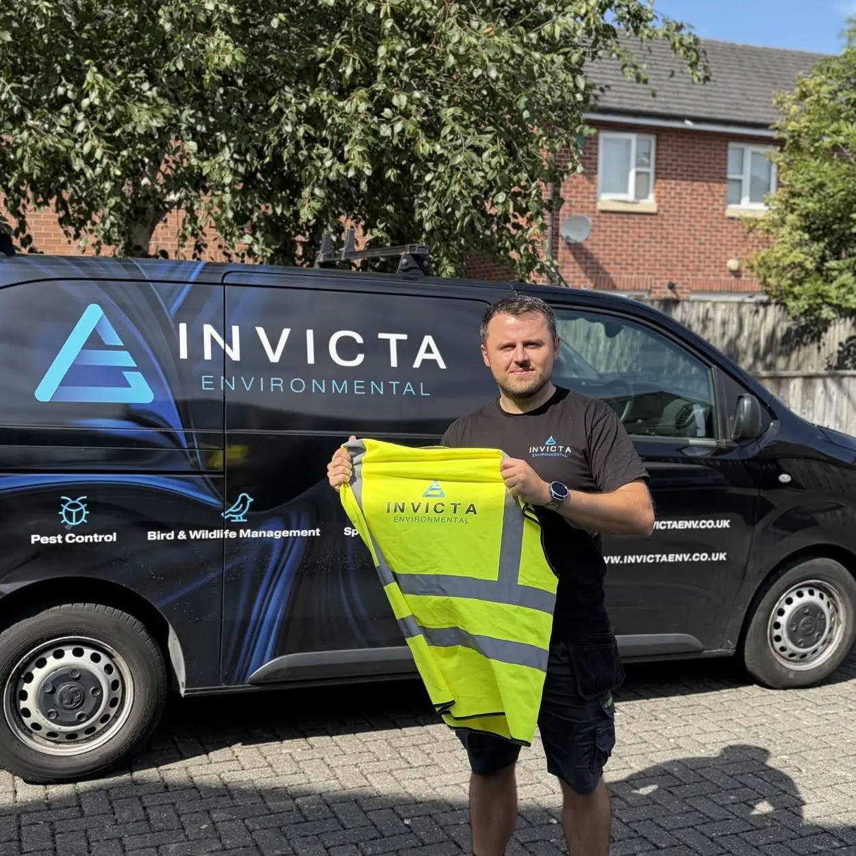 Invicta Pest Controller standing in front of a branded van